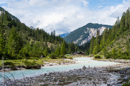 view on isar river and mountains near the isar origin in scharnitz, austria