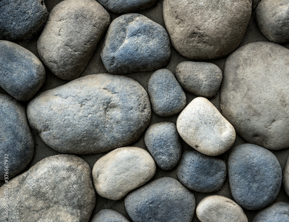 Stone background. Wall of rounded pebbles. Stone background. Wall of rounded pebbles.