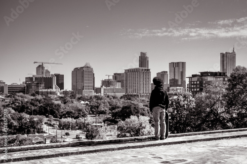 Skateboarder with Austin cityscape