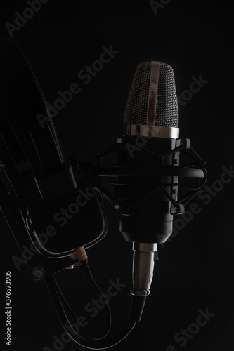 Studio professional microphone on a black background, work with vocals, with sound