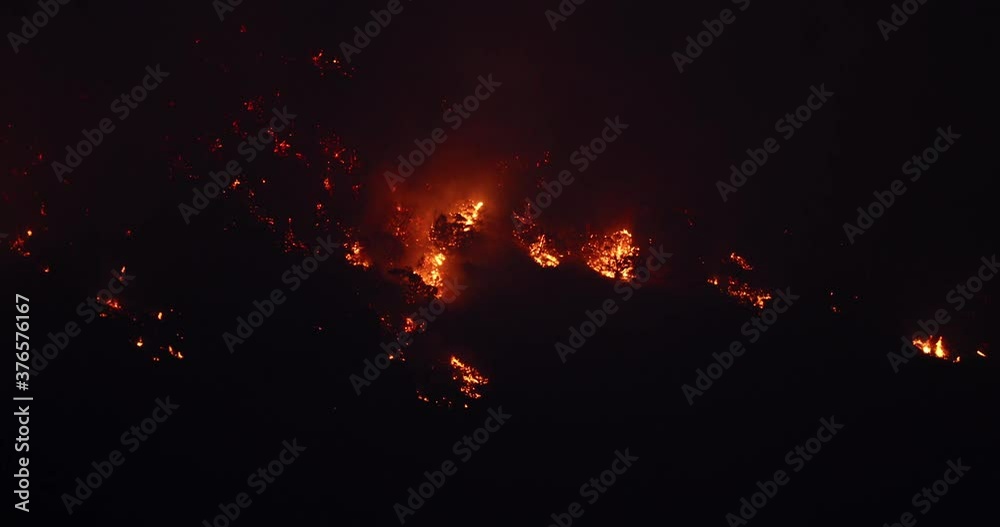 Forest fire dark night high wilderness mountain Utah. Intense man caused wild and forest fire destroyed a mountain side and valley. Fire fighting crew on ground supported by aircraft and helicopters. Forest fire dark night high wilderness mountain Utah. Intense man caused wild and forest fire destroyed a mountain side and valley. Fire fighting crew on ground supported by aircraft and helicopters.