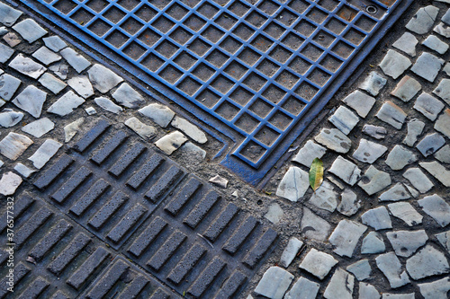 Sidewalk mosaic and manhole cover detail
