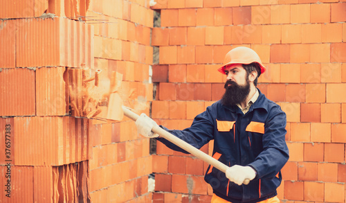 Photography Adult handsome worker builder using hammer and smash tool at construction site