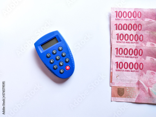 Blue security key bank token and Rupiah banknotes photo