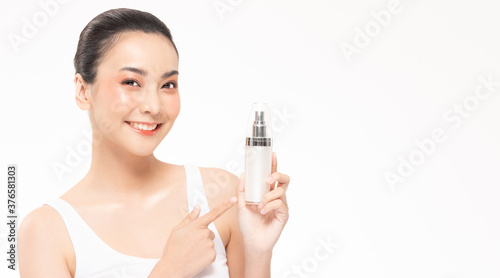 Beauty asian woman hold bottle cosmetic cream lotion and cheerful.