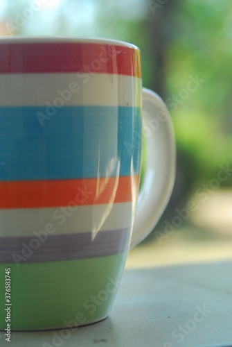 Beautiful field meadow flowers chamomile, blue wild peas in morning against blue sky with clouds, nature landscape, close-up macro. Wide format, copy space. Delightful pastoral airy artistic image.