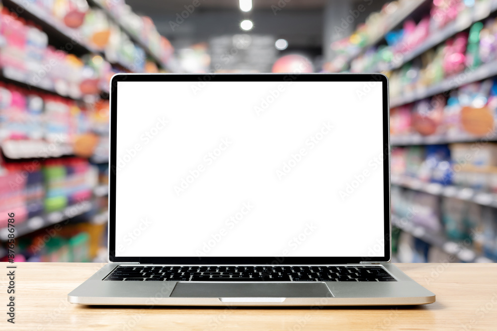 Laptop blank screen on wood table with supermarket in department store ...