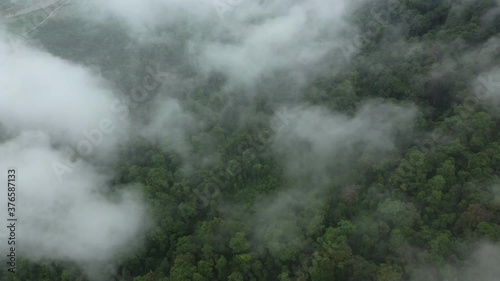 Clouds over mountains and lush tropical jungle in Asia, Laos, Khammouane, towards Thakek, on a cloudy day.