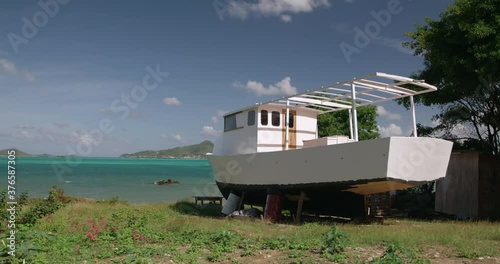 Traditional sloop boat being constructe, with island views, Windward, Carriacou, Grenada photo