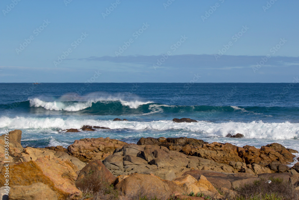 Huge  frothy waves of the Indian Ocean rolling in at famous Yallingup Beach,South Western Australia a world famous surfing mecca, on a cold yet sunny late winter morning.