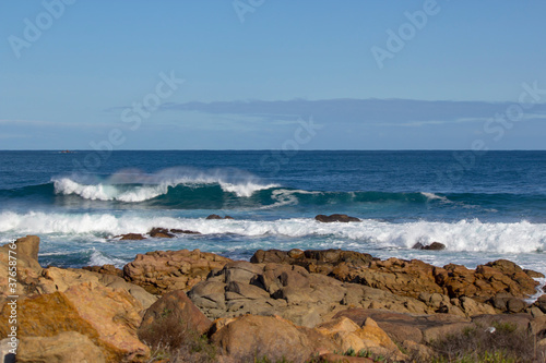 Huge  frothy waves of the Indian Ocean rolling in at famous Yallingup Beach,South Western Australia a world famous surfing mecca, on a cold yet sunny late winter morning. © allymoon