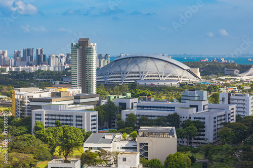 view of the Singapore Sports Hub with residential areas and the sea in the background