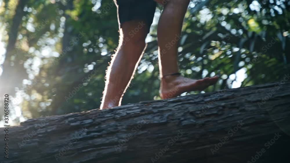 Jungle boy walking on a tree at Huay To Waterfall, Krabi Jungle boy walking on a tree at Huay To Waterfall, Krabi