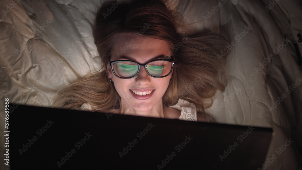 Top View Young Woman in Bed Working on a Laptop Computer at Night. Student Getting Ready to Exams, Exceptionally Dedicated Project Manager Finishing Work in Bed at Night.