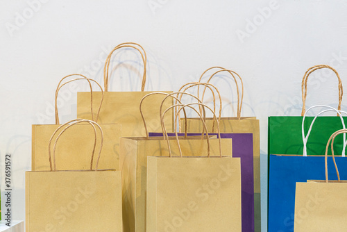 Different sizes of Brown recycled paper shopping bag and Different color paper shopping bag with handles for shopping. Blank packaging, Shopping bag paper, Branding packaging template. Copy space