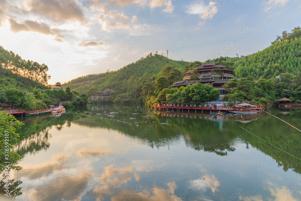 Small mountain lake reflection and ancient building landscape in Chinese park