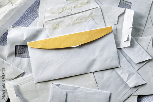 фотографія Yellow seal flap enveloped opened and stacked on top of other read mails