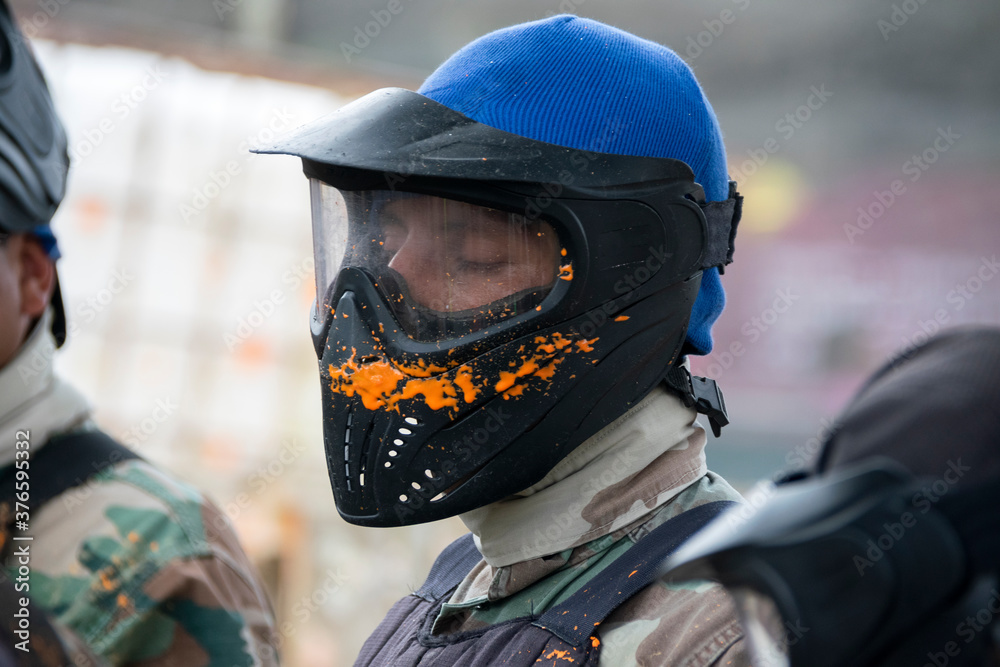 Person hit with paintball in game of Gotcha, protection and fun. Person hit with paintball in game of Gotcha, protection and fun.