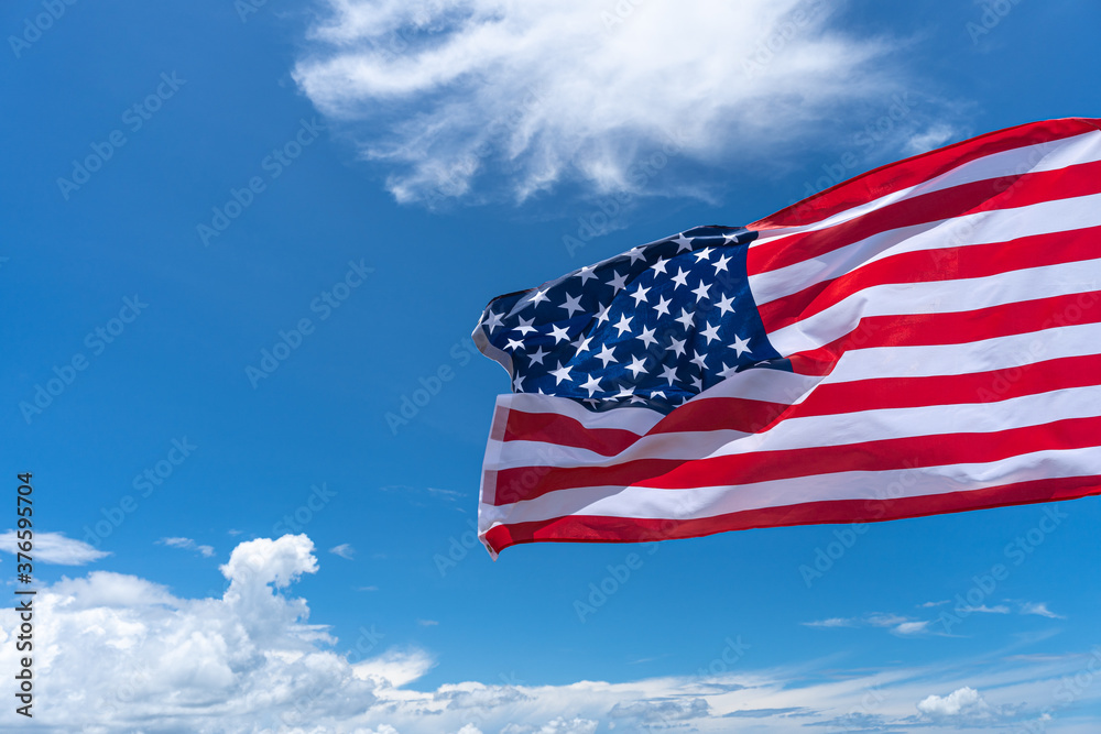 Waving USA flag under blue sky background. Waving USA flag under blue sky background.
