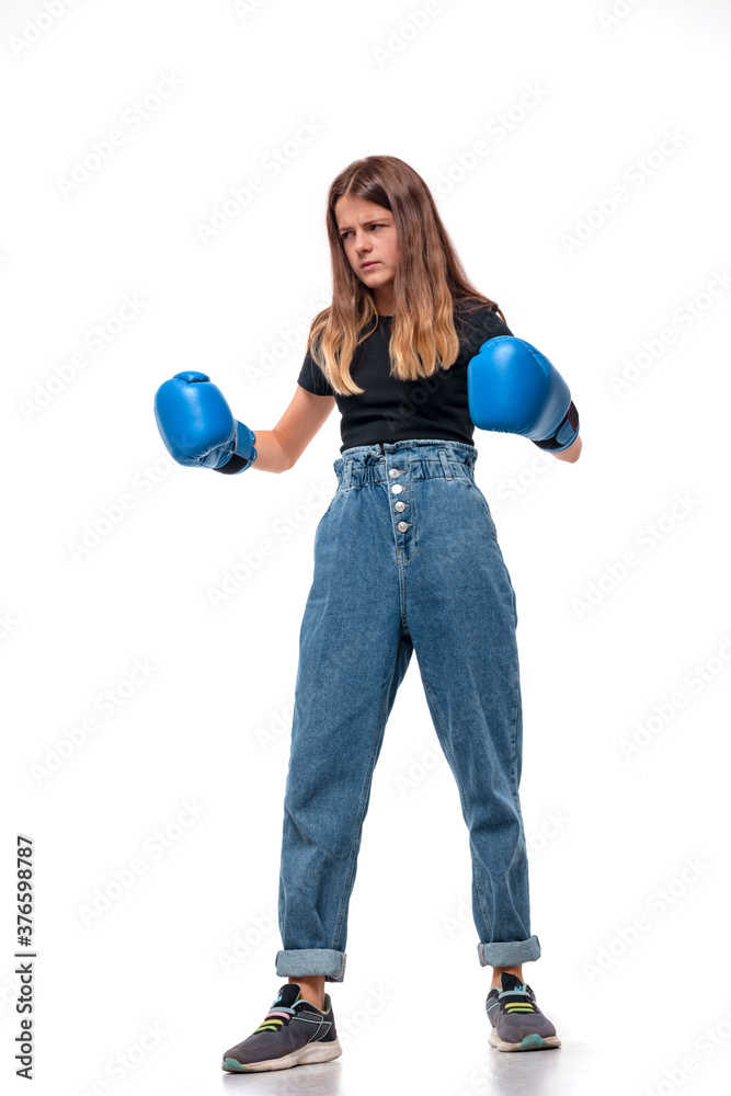 Сonfident girl in blue boxing gloves focused to win, isolated Сonfident girl in blue boxing gloves focused to win, isolated