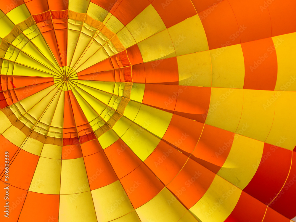 Bright yellow and orange fragment of hot air balloon shot from below Bright yellow and orange fragment of hot air balloon shot from below