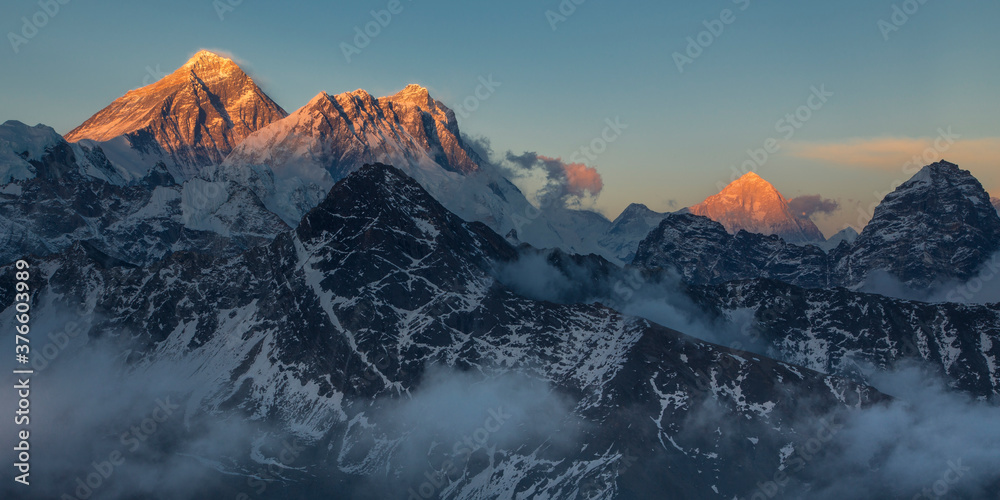 Mounts Everest, Lhotse and Makalu at sunset with tops lightened by the last golden sunlight Mounts Everest, Lhotse and Makalu at sunset with tops lightened by the last golden sunlight
