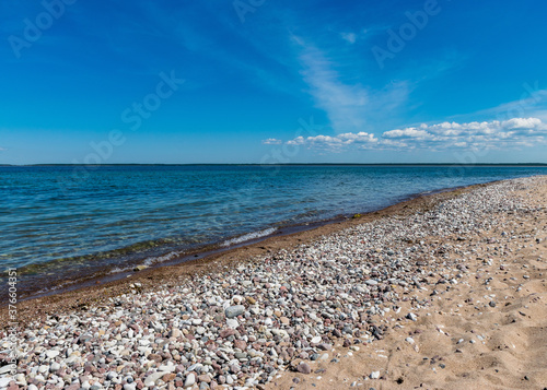 traditional summer landscape with sandy and pebbly promontory, blue sea and sky, Harilaid Nature Reserve, Estonia, Baltic Sea