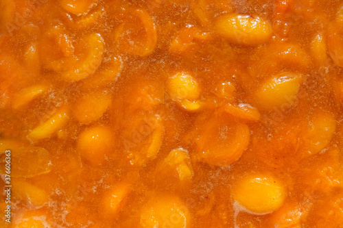Natural texture of bright orange apricot jam. Homemade preparations for the winter-jam. The view from the top. Close up.