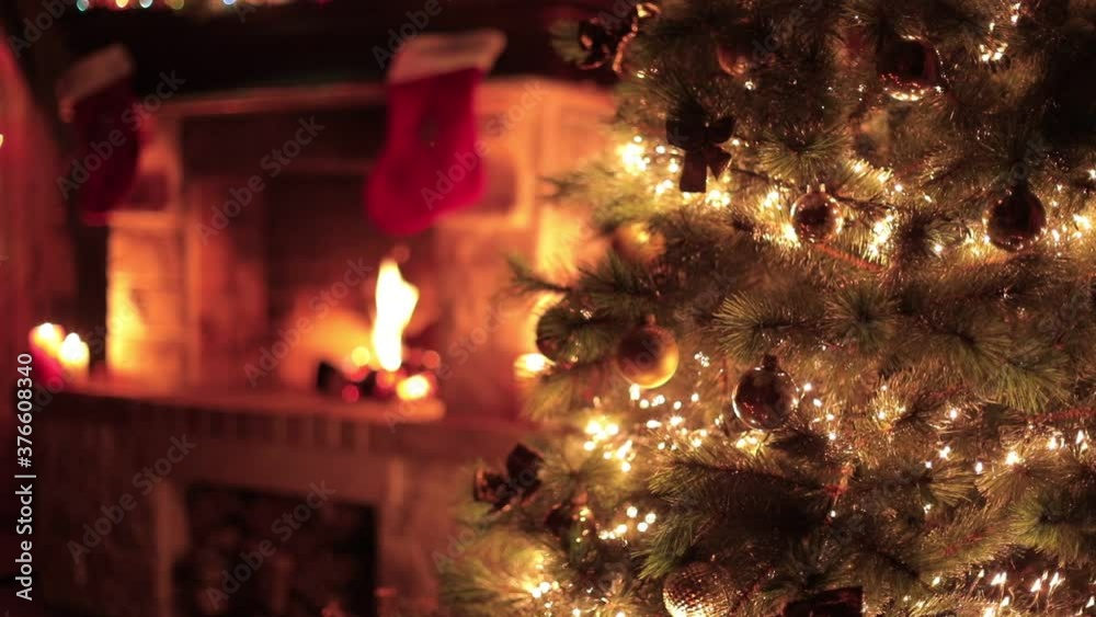 Christmas decorated tree closeup with fireplace