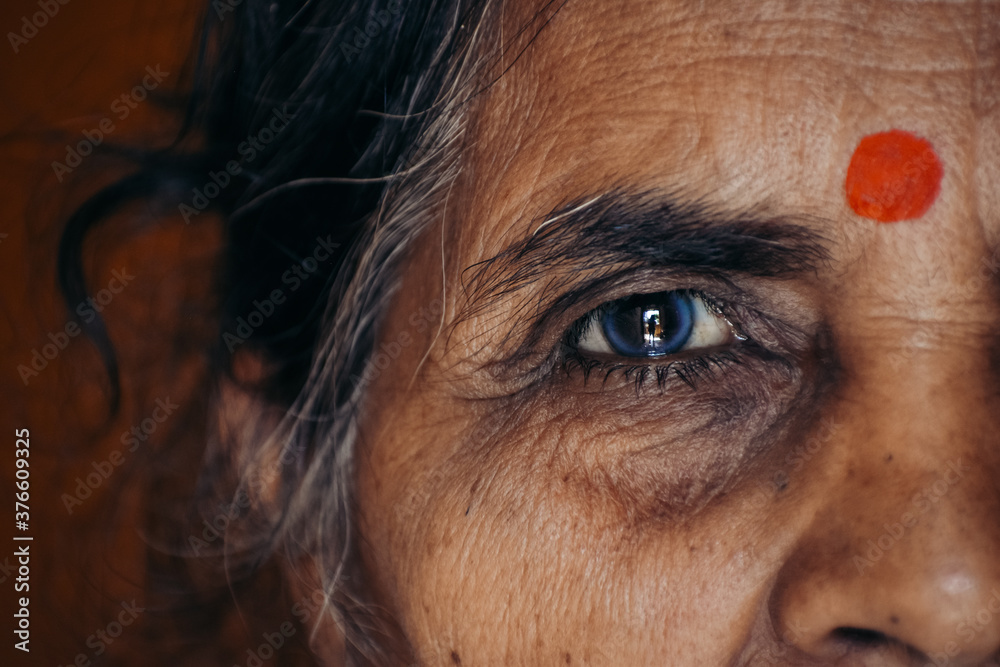 Closeup shot of eye of an old Indian lady - obrazy, fototapety, plakaty 