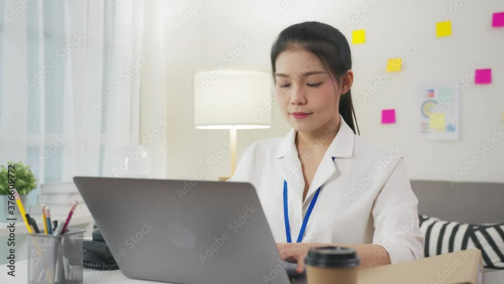 Asian businesswoman consultant of customer support phone operator and using laptop on the office. Asian businesswoman consultant of customer support phone operator and using laptop on the office.