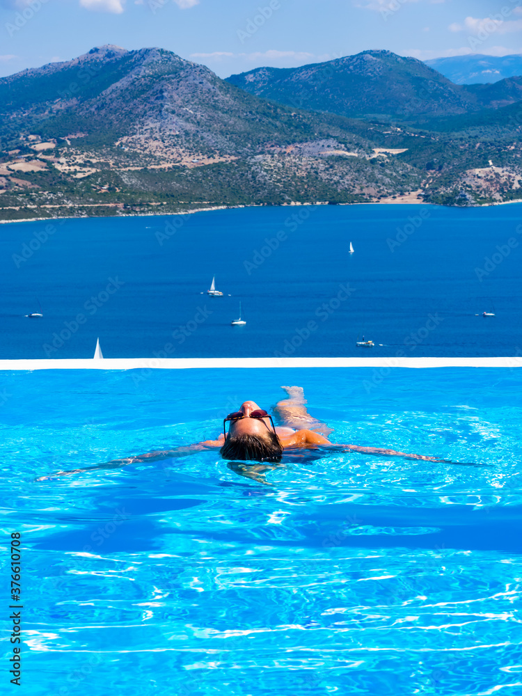 Woman at the infinity swimming pool