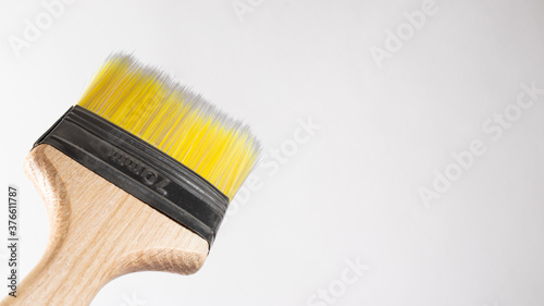 A paint brush on a gray background with a place for text to paint walls and objects with paint. Tools for repair.