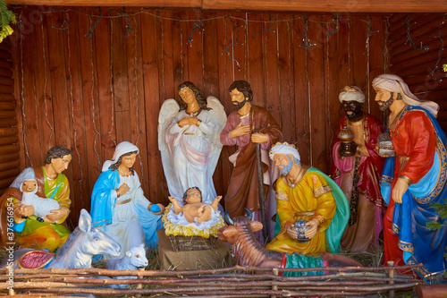 Christmas nativity scene,Christmas statues of the nativity scene Jesus in the hay, Mary with Joseph and kings and an angel and a shepherd with a sheep and a cow