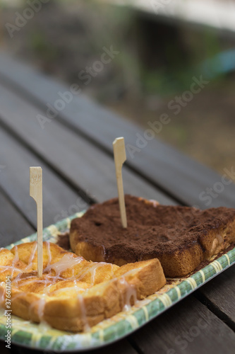 Slices of bread with milk and chocolate powder