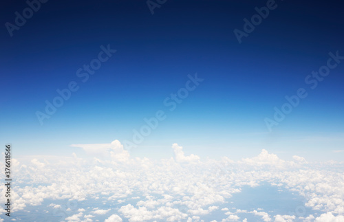 Blue sky background and white clouds soft focus, top view take a picture on airplane.