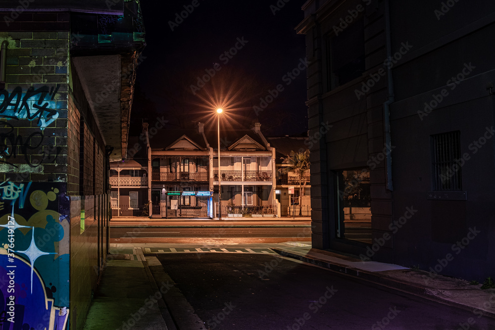 terrace houses and empty street at night