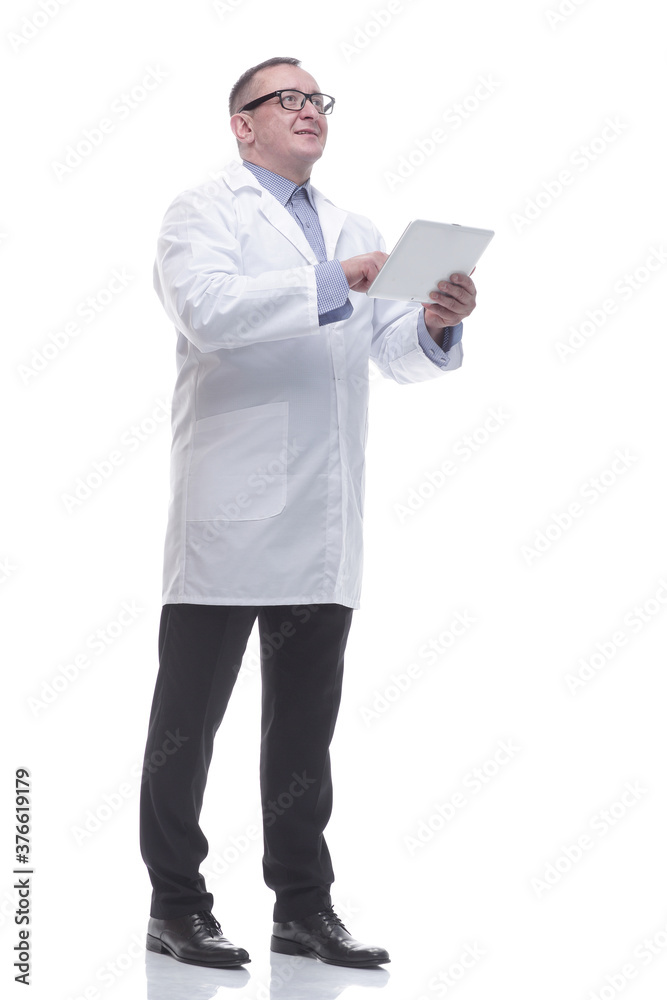 in full growth. a competent mature doctor with a digital tablet. in full growth. a competent mature doctor with a digital tablet.