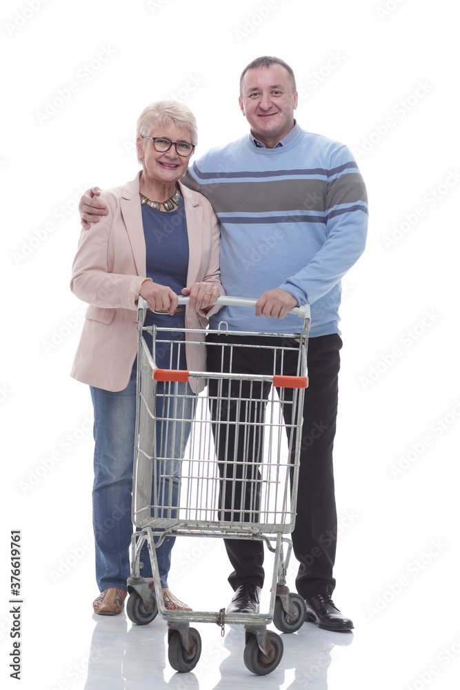 in full growth. an adult couple with a shopping cart. in full growth. an adult couple with a shopping cart.