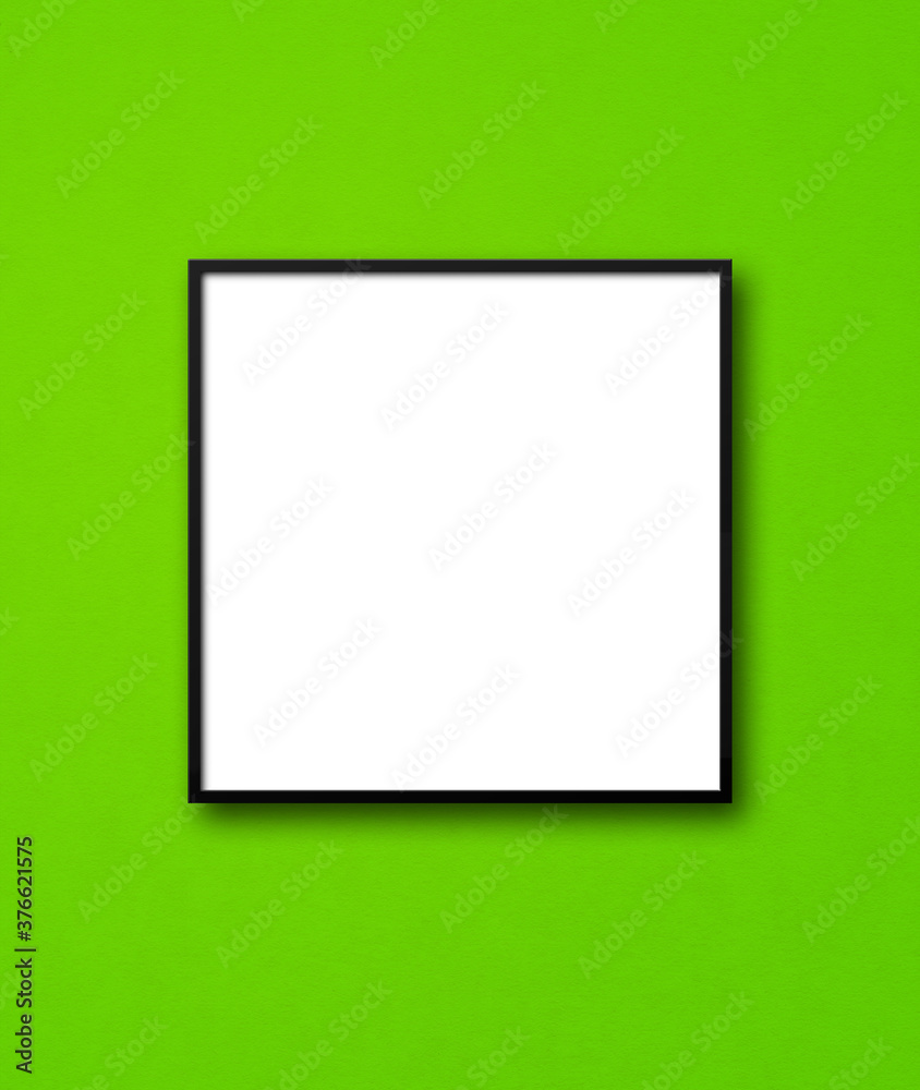 Black square picture frame hanging on a green wall Black square picture frame hanging on a green wall