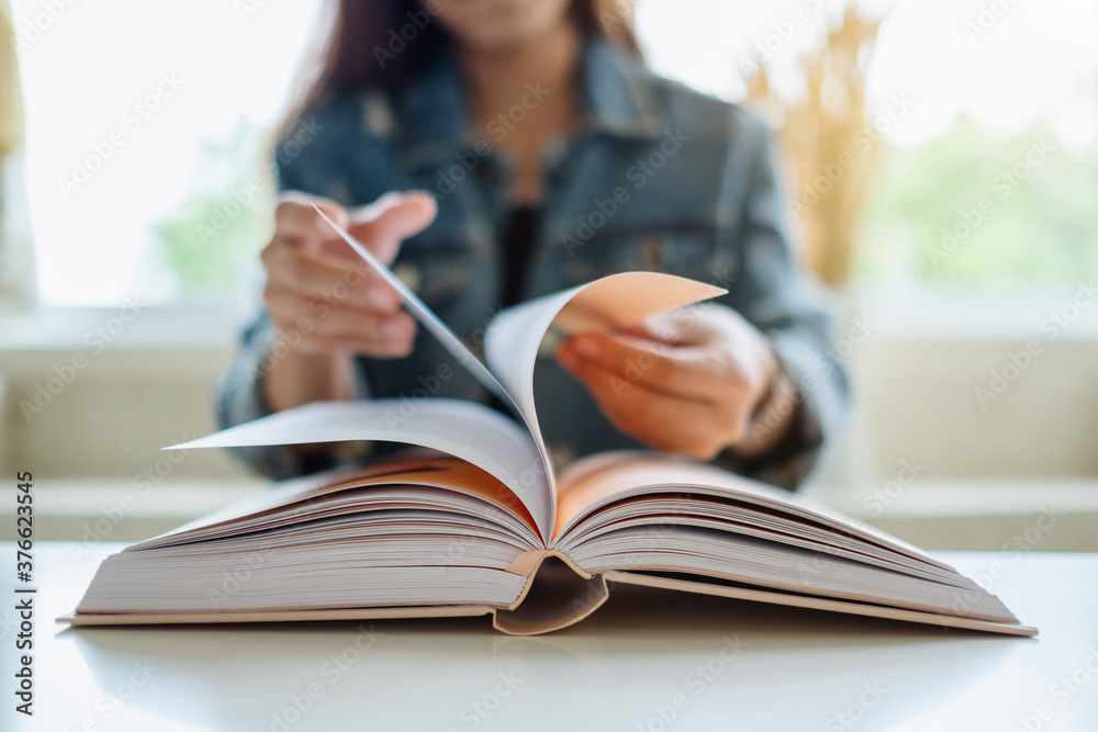 Closeup image of a woman opening and reading book Closeup image of a woman opening and reading book