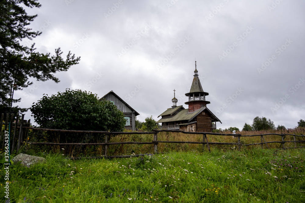 wooden ancient church on the island among the trees during the rain wooden ancient church on the island among the trees during the rain
