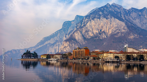 Lecco, Italy, February 16, 2020. The picturesque embankment of Lake Como in cloudy weather and the mountains behind it. 