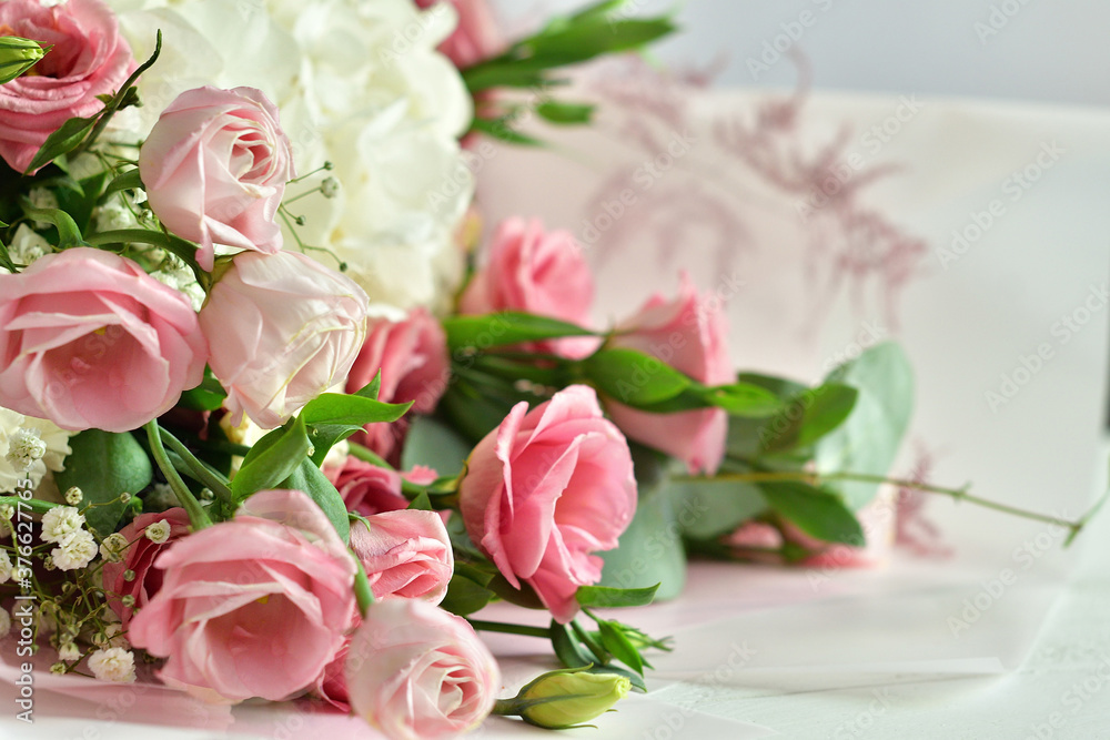bouquet of delicate roses, eustoma, hydrangea on light background.Flowers composition.Mother's Day, Valentine's Day,birthday. Copy space. I love you concept.Wedding invitation. bouquet of delicate roses, eustoma, hydrangea on light background.Flowers composition.Mother's Day, Valentine's Day,birthday. Copy space. I love you concept.Wedding invitation.