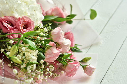 bouquet of delicate roses, eustoma, hydrangea on light background.Flowers composition.Mother's Day, Valentine's Day,birthday. Copy space. I love you concept.Wedding invitation. © Natasha 