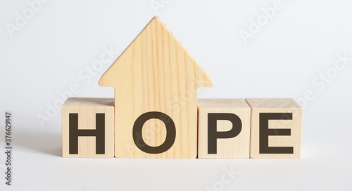 Wooden blocks with the word HOPE , house. The concept of the high cost of rent for an apartment or home.