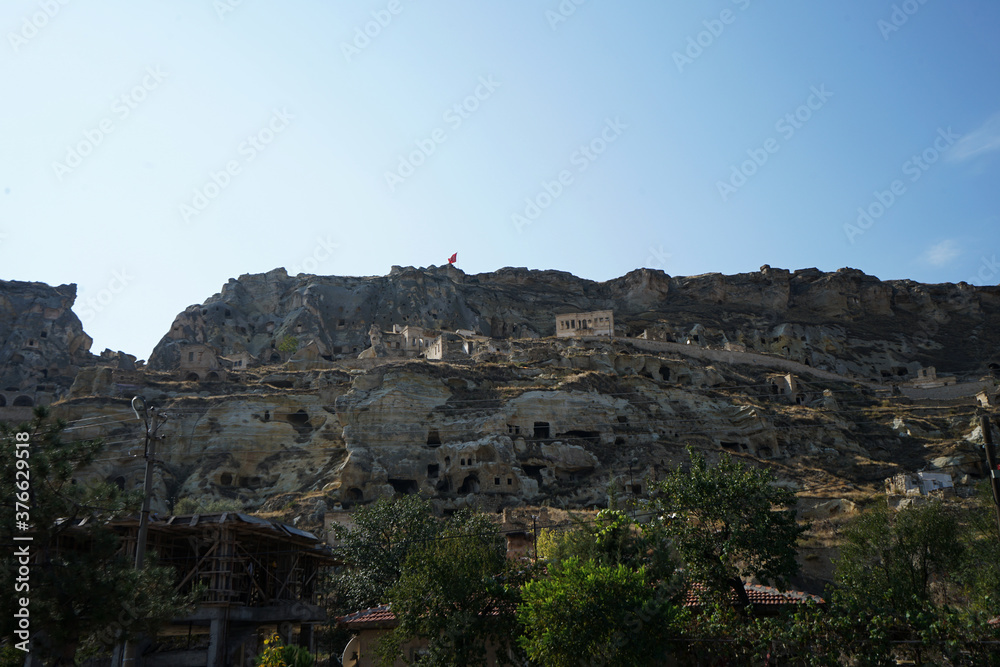 Natural landscape of Cappadocia, semi-arid region in central Turkey known for its distinctive fairy chimneys, tall cone-shaped rock formations clustered in Monks Valley, Göreme and elsewhere- Kayseri