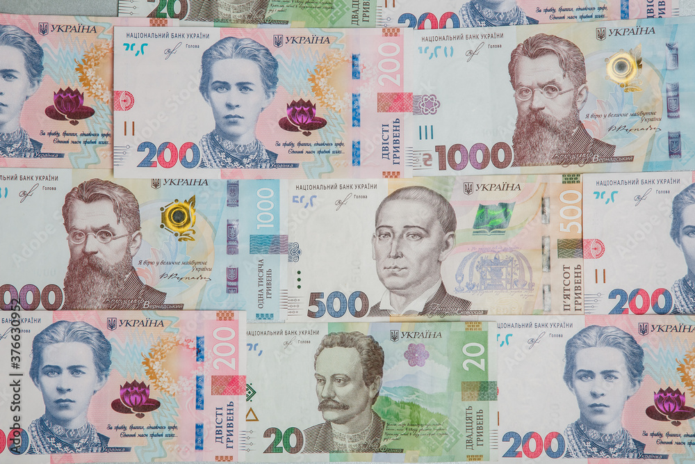 Background from the new banknotes of the Ukrainian hryvnia. Ukrainian money. A bill of one thousand hryvnia, five hundred and two hundred hryvnia and twenty hryvnia lying side by side.