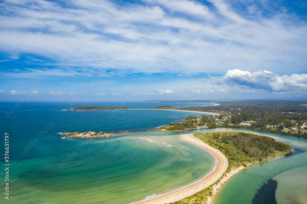 Panoramic aerial view of the beautiful Tomakin Beach and inlet to Tomaga River at Tomakin on the New South Wales South Coast, Australia 