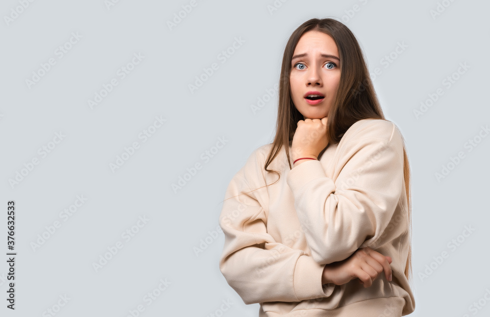 Studio shot of Scared young woman isolated on white background. Copy space Studio shot of Scared young woman isolated on white background. Copy space